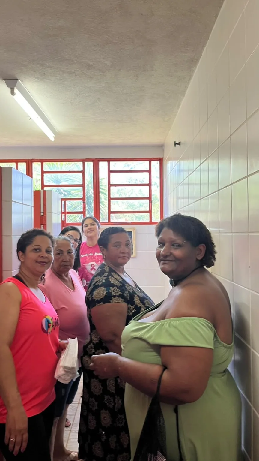 Mulher recebe atendimento de trancista durante programação do Outubro Rosa